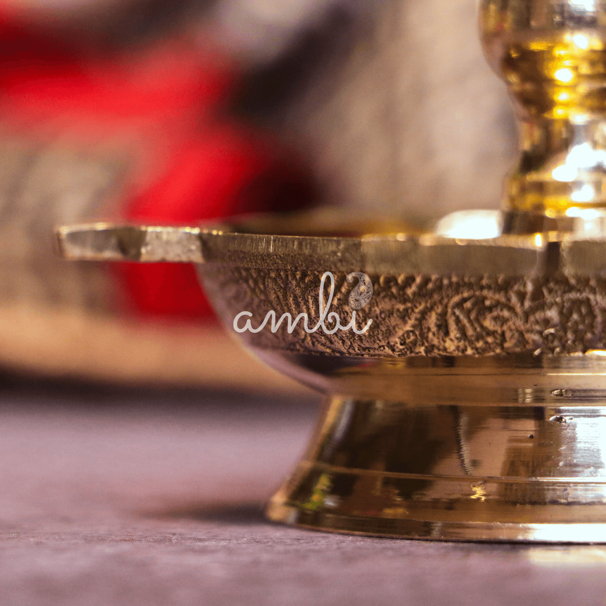 Close-up of a decorative gold bowl with intricate patterns on a blurred background