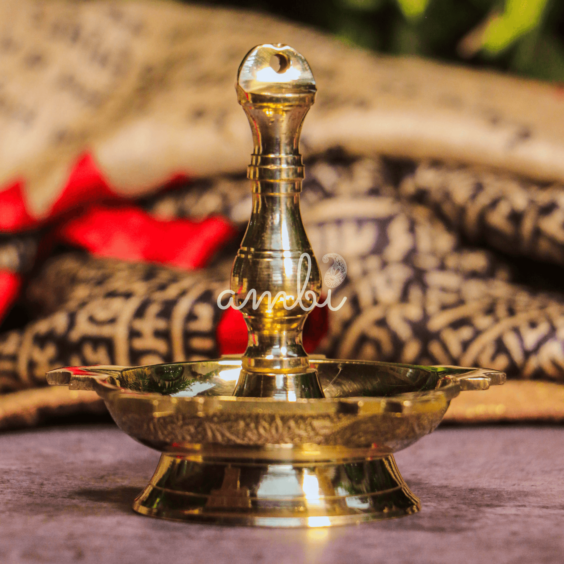 Brass oil lamp on a textured surface with a blurred background